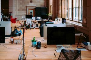an empty office with desks and computers